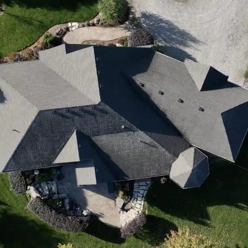 Aerial view of a finished, evenly treated asphalt shingle roof